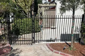 Residential metal fence installation in Los Angeles with black steel picket fencing for home security and curb appeal